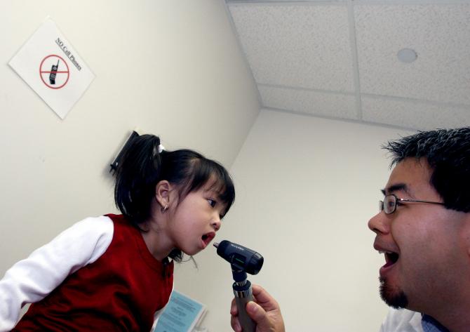 Doctor examining a young girl